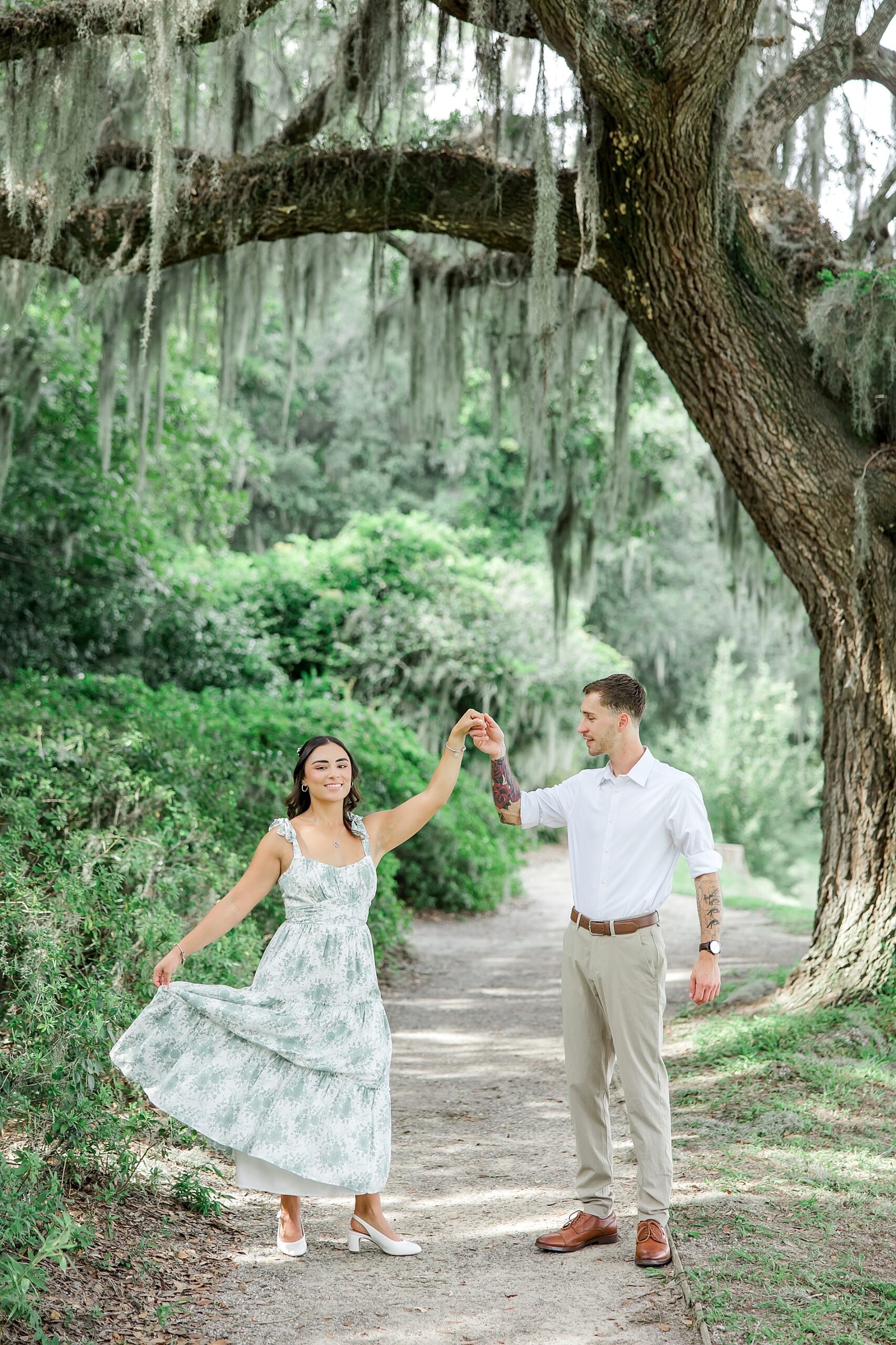 couple dancing under oak tree covered in Spanish Moss