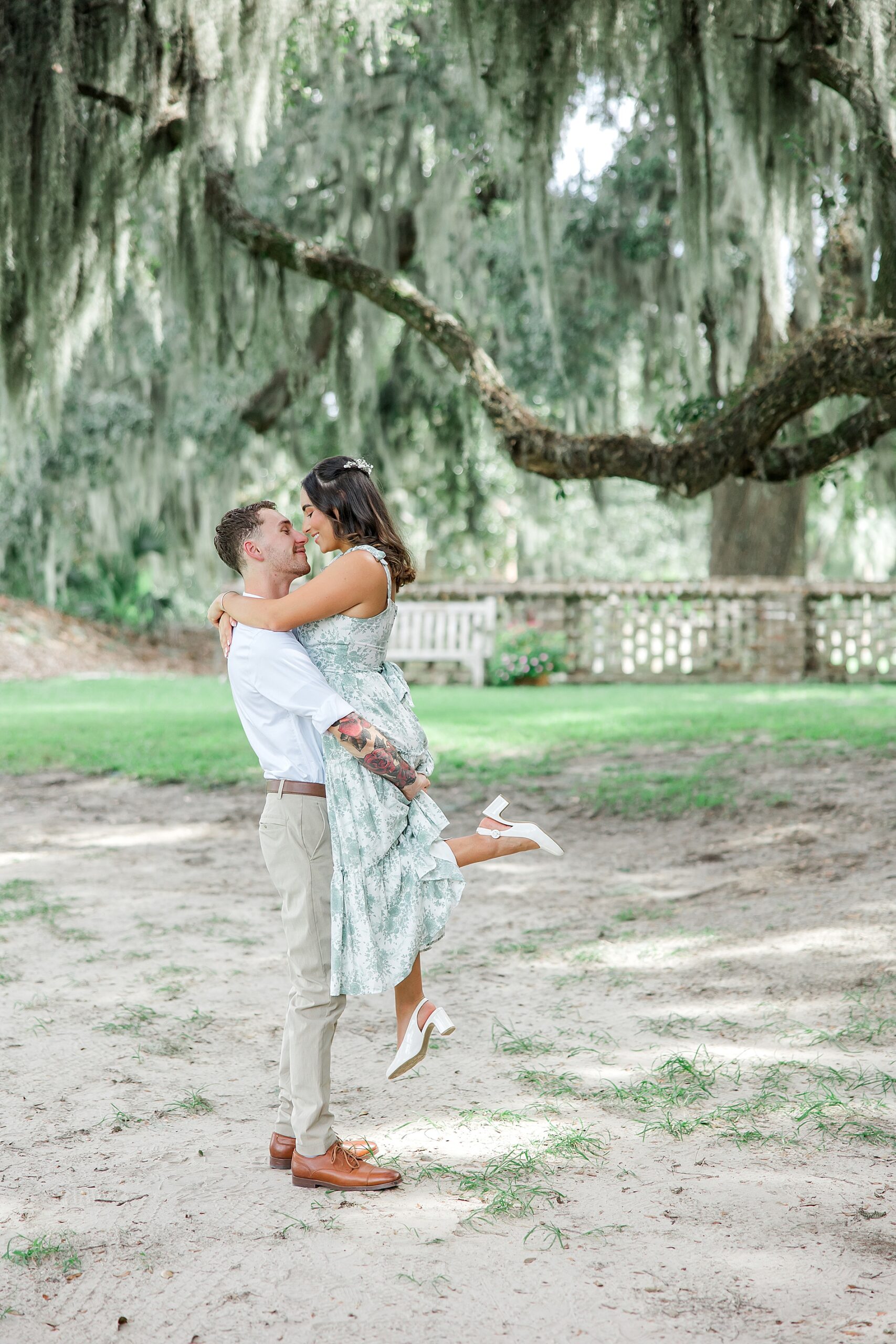 timeless engagement portraits of man lifting up his fiance