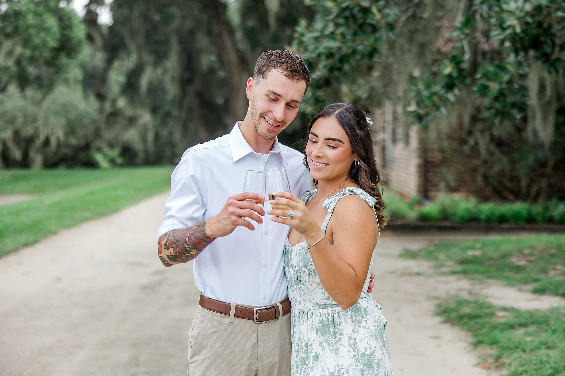 newly engaged couple cheers with chamoagne